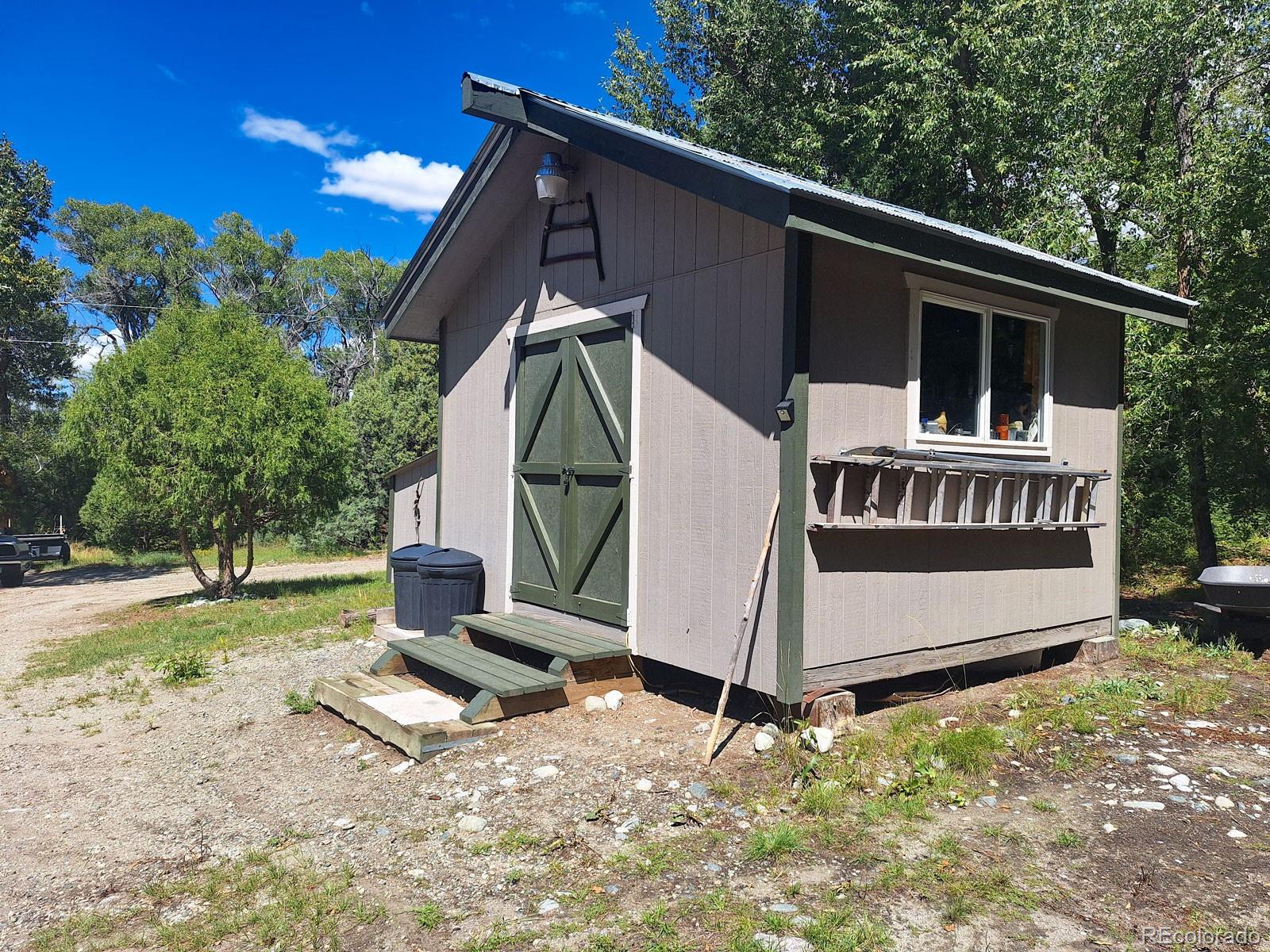203 Hampton Run Road Mosca, CO 81146 - Photo 31 of 33 a view of a small house in the background with a bench