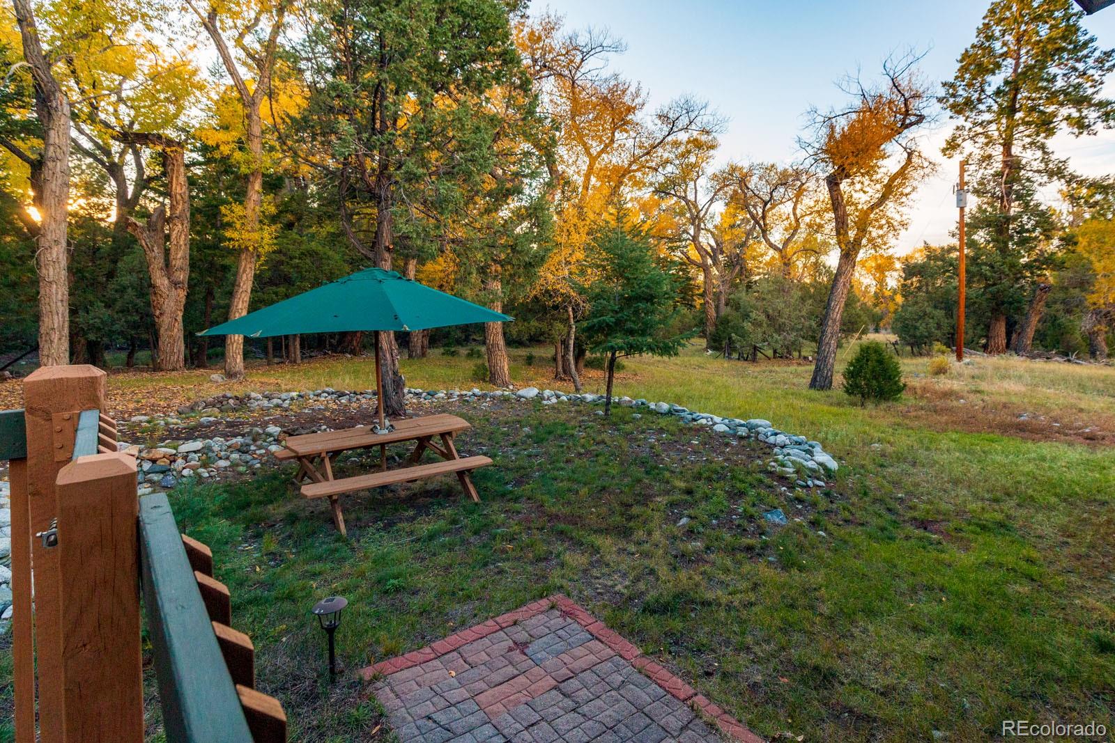 203 Hampton Run Road Mosca, CO 81146 - Photo 8 of 33 a view of a table and chairs under an umbrella