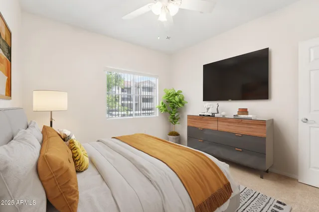 a bedroom with a bed and a flat screen tv