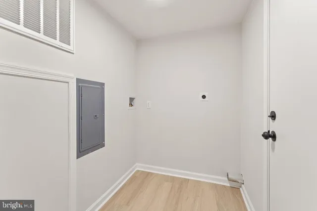 a view of a room with wooden floor and cabinet