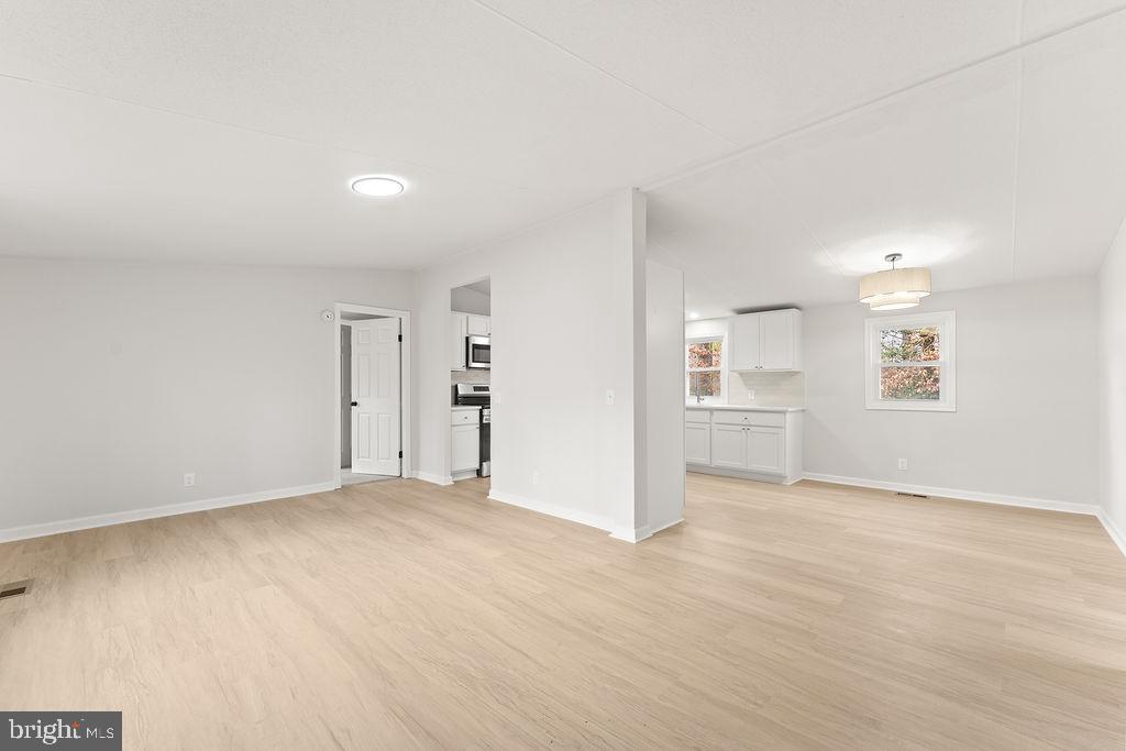 10022 Kentucky Springs Road Mineral, VA 23117 - Photo 2 of 31 an empty room with windows and wooden floor