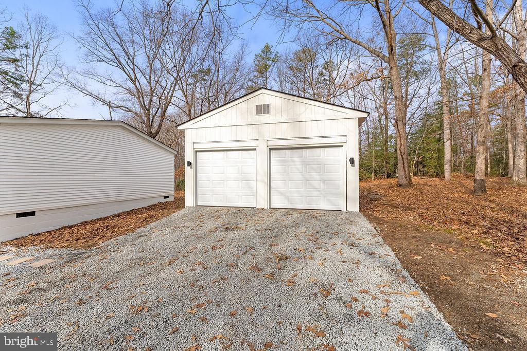 10022 Kentucky Springs Road Mineral, VA 23117 - Photo 31 of 31 a front view of a house with a yard and garage