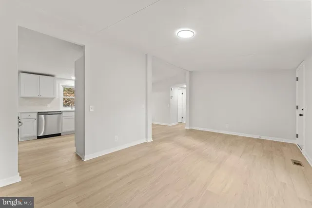 a view of a kitchen with a sink and a refrigerator