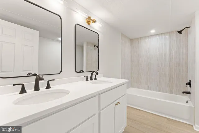 a bathroom with a double vanity sink and a mirror
