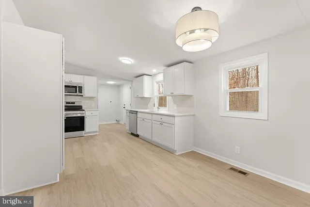 a view of a kitchen with microwave and cabinets