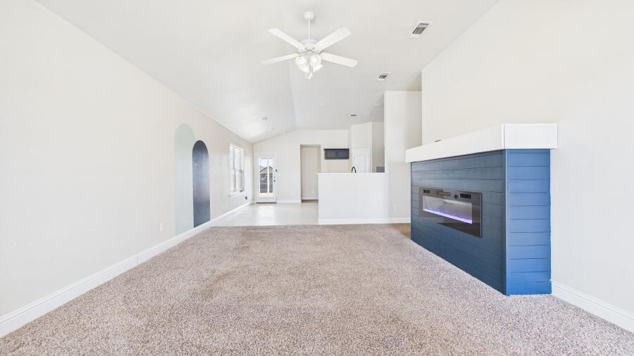 3707 Rochester Avenue Lubbock, TX 79407 - Photo 9 of 40 a view of a livingroom with a kitchen and a fireplace