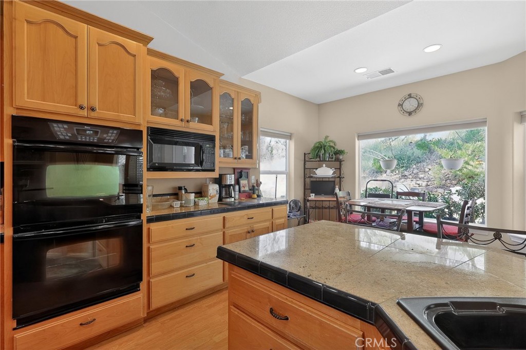 19370 Park Ridge Drive Hidden Valley Lake, CA 95467 - Photo 29 of 61 a kitchen with stainless steel appliances granite countertop a stove a sink and a microwave