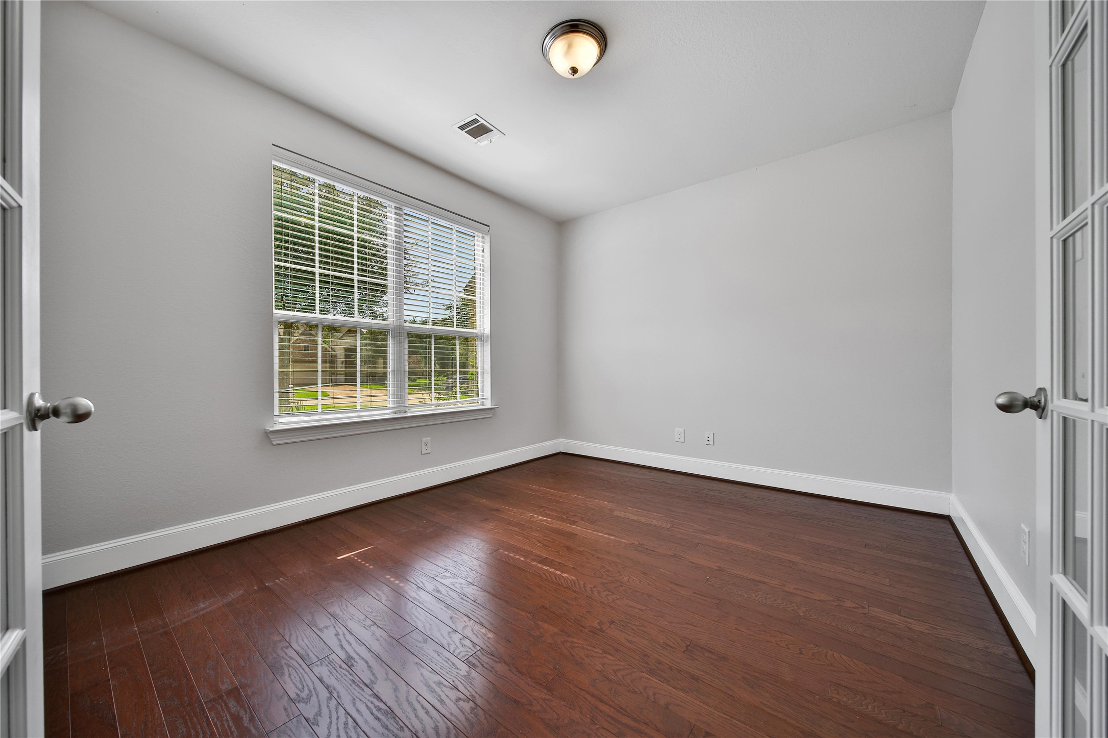 3910 Lupin Bush Lane Manvel, TX 77578 - Photo 10 of 30 an empty room with wooden floor and windows