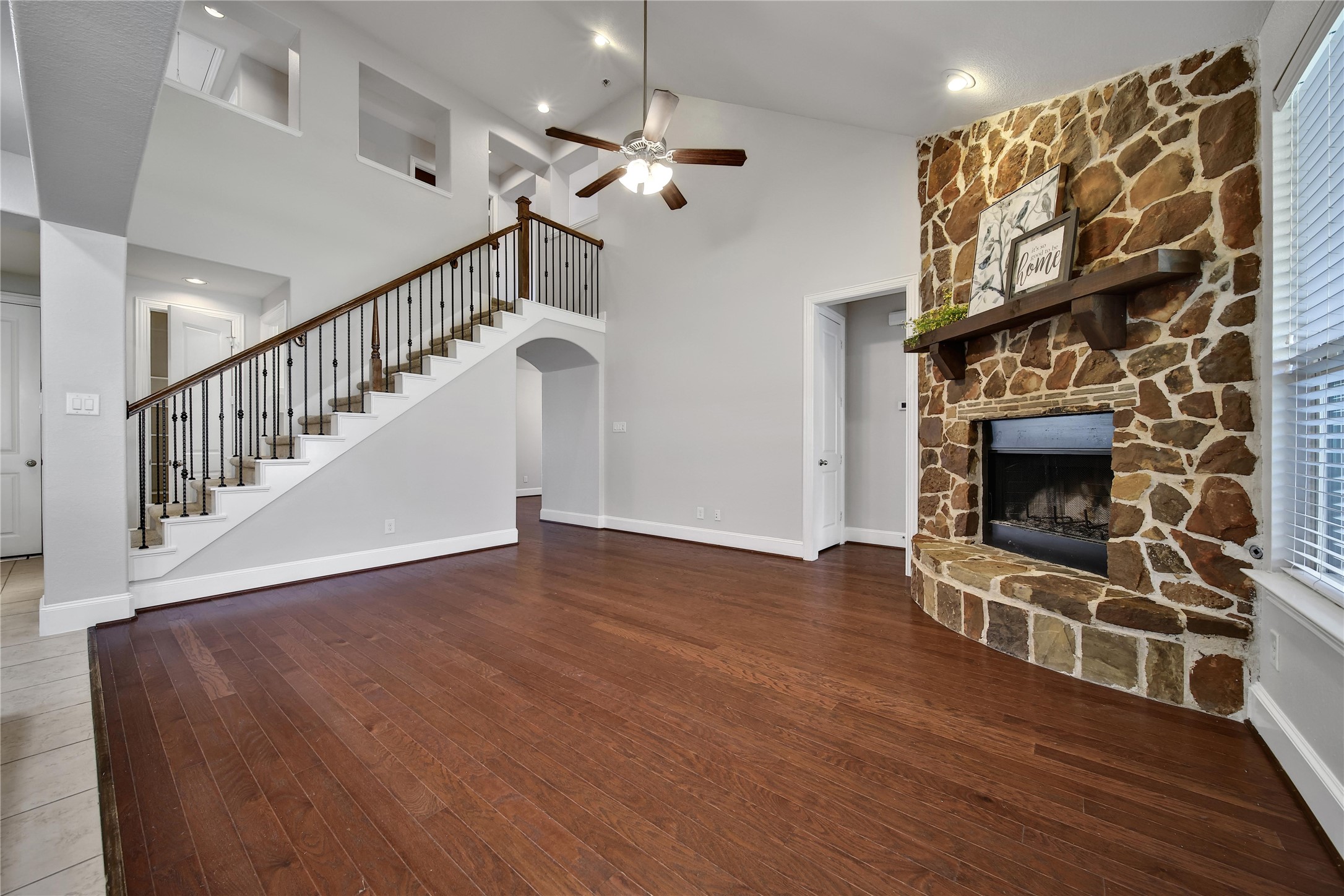 3910 Lupin Bush Lane Manvel, TX 77578 - Photo 12 of 30 a view of an empty room with wooden floor fireplace and a window