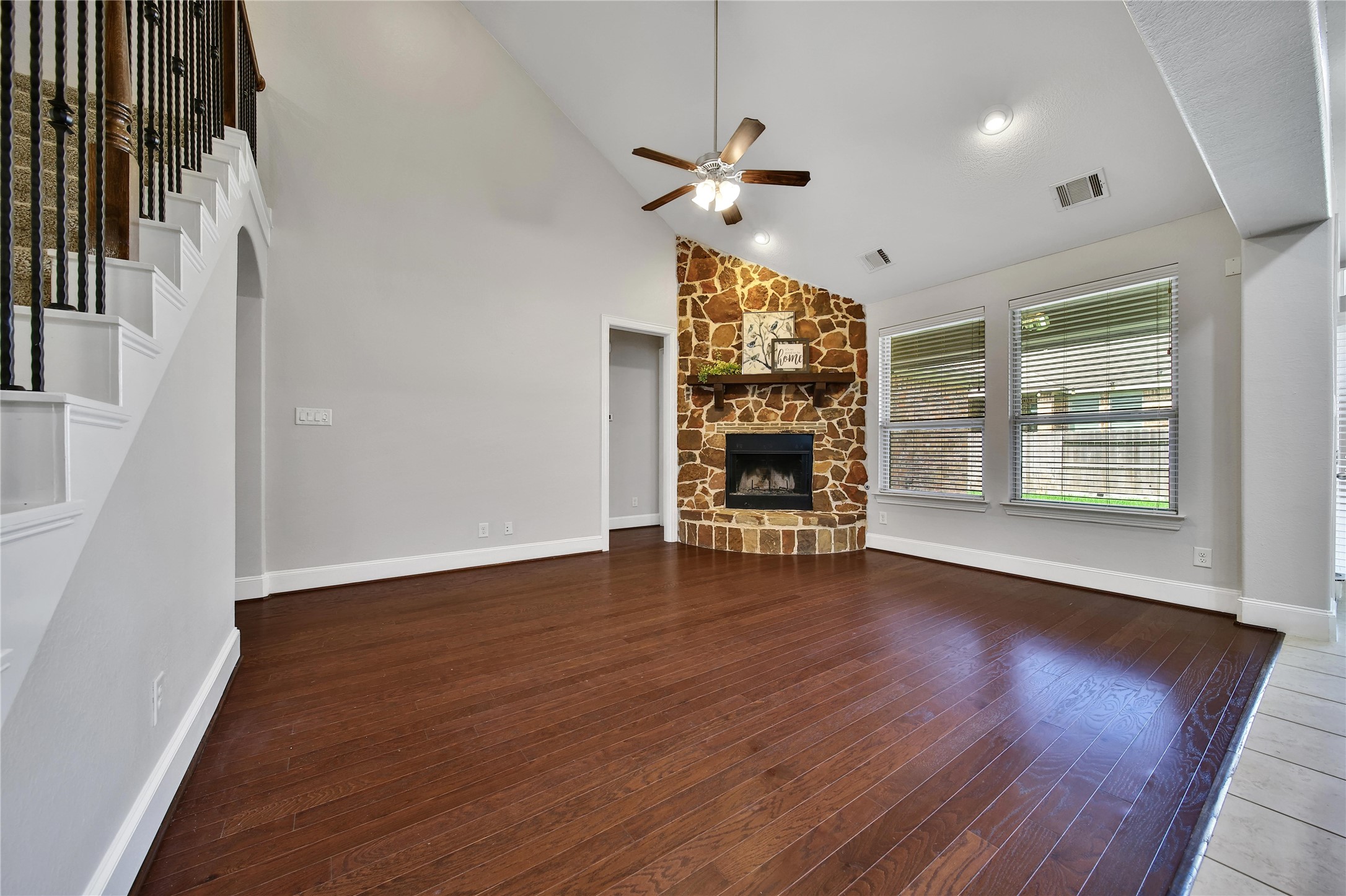 3910 Lupin Bush Lane Manvel, TX 77578 - Photo 13 of 30 a view of an empty room with wooden floor fireplace and a window