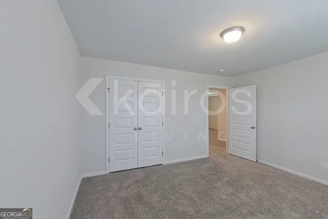 an empty room with closet area