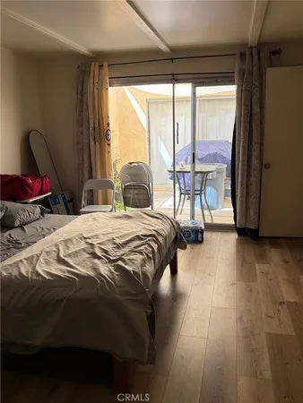 a bed sitting in a bedroom next to a window