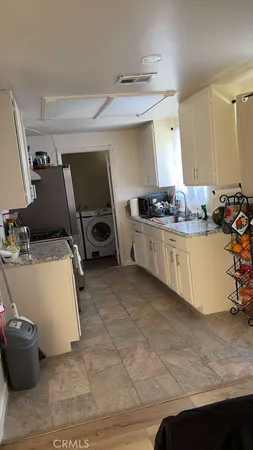 a kitchen with a sink and wooden cabinets