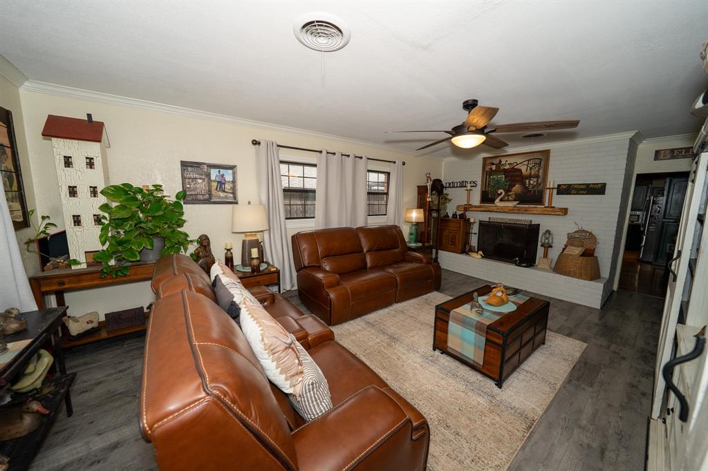 455 5th Street Hawley, TX 79525 - Photo 4 of 37 a living room with furniture a fireplace and a flat screen tv