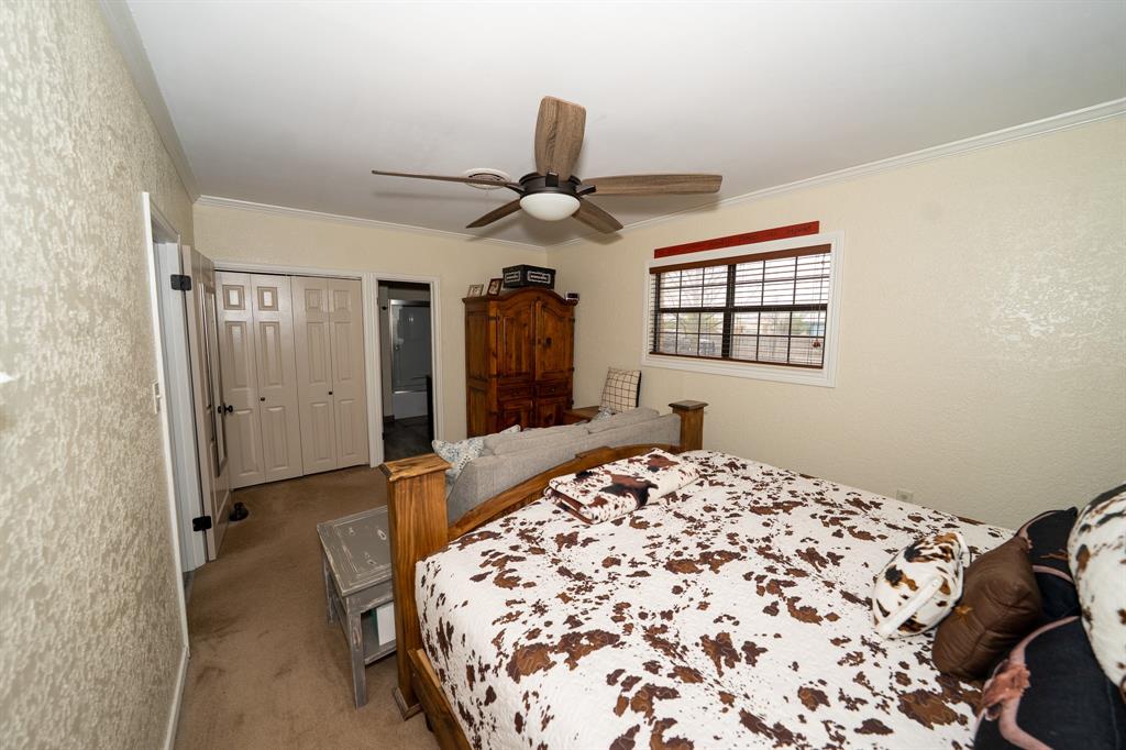 455 5th Street Hawley, TX 79525 - Photo 8 of 37 a bedroom with a bed and a chandelier