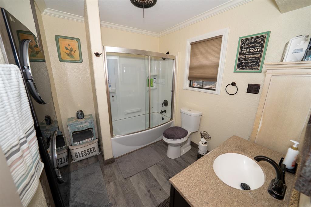455 5th Street Hawley, TX 79525 - Photo 9 of 37 a bathroom with a toilet a sink and shower