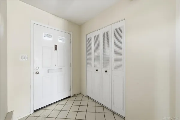 a view of an empty room with closet area