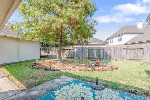 a view of a backyard with plants and patio