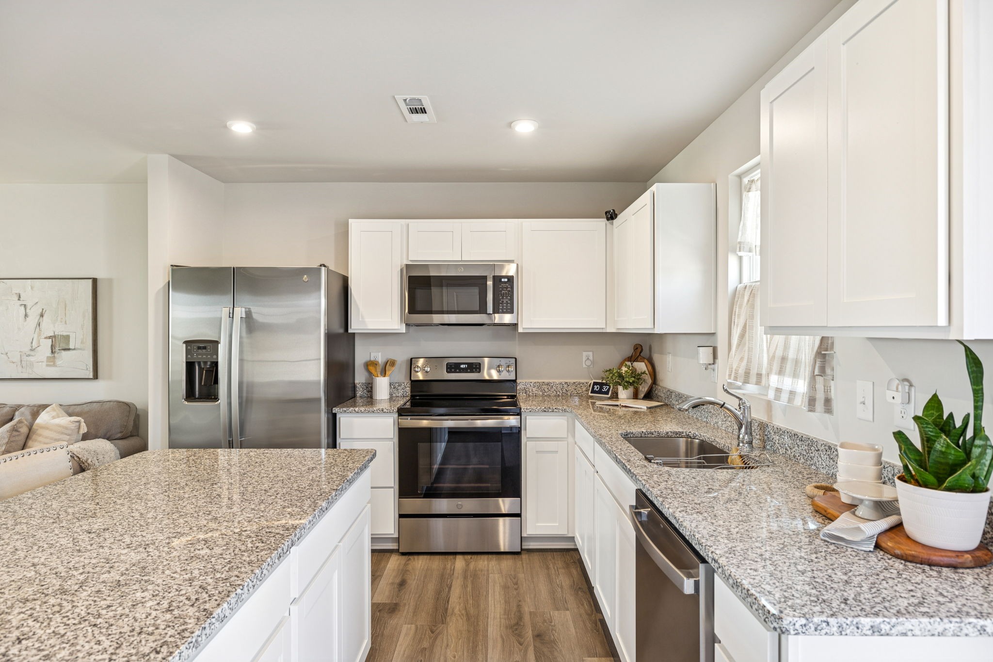 2116 Somersby Trail Spring Hill, TN 37174 - Photo 14 of 45 a kitchen with granite countertop a sink stove and refrigerator