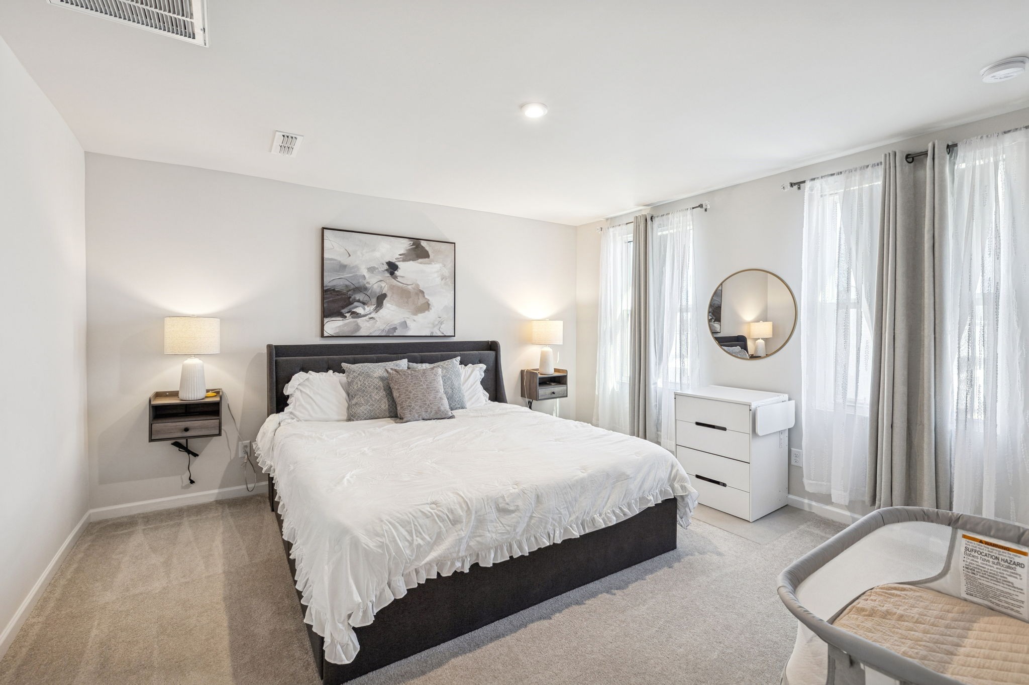 2116 Somersby Trail Spring Hill, TN 37174 - Photo 33 of 45 a bedroom with a bed and a lamp on dresser with wooden floor