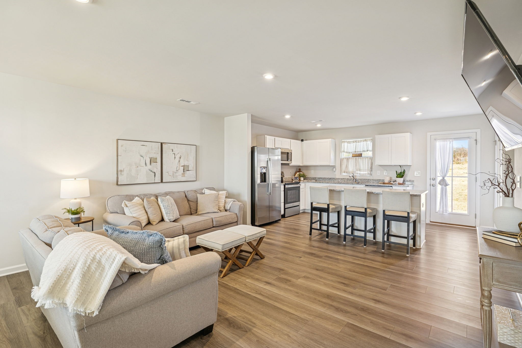 2116 Somersby Trail Spring Hill, TN 37174 - Photo 10 of 45 a living room with furniture and a dining table with wooden floor