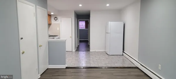 a view of a hallway with wooden floor