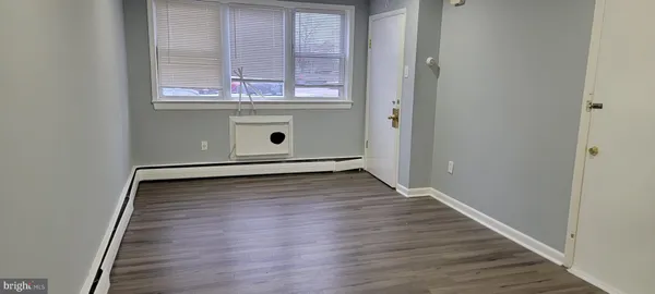 a view of room with window and wooden floor
