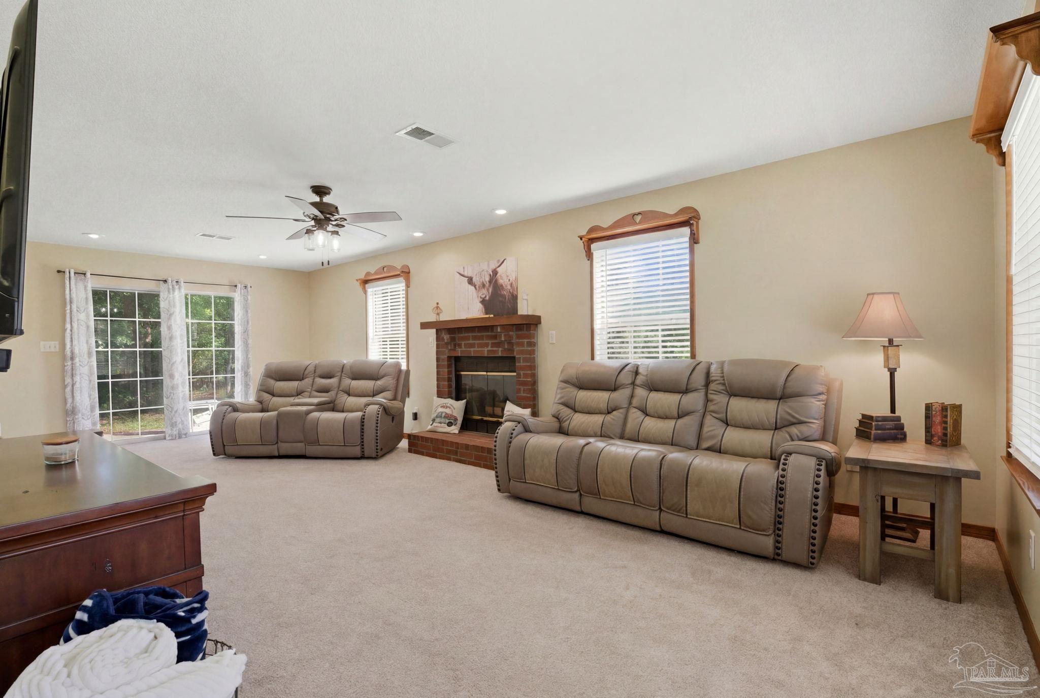 6870 Martin Road Milton, FL 32570 - Photo 15 of 48 a living room with furniture and a fireplace