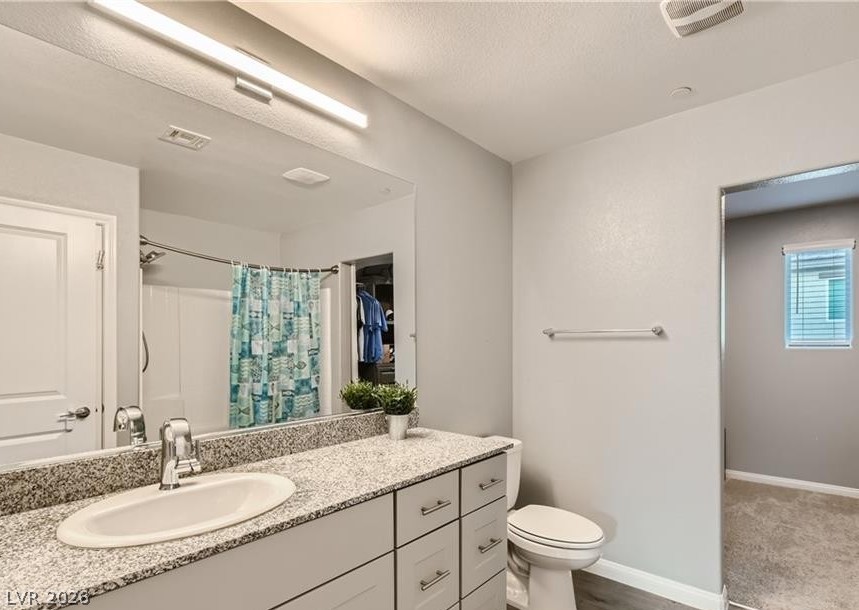 12110 Midnight Pine Road, Unit 3 Las Vegas, NV 89183 - Photo 6 of 13 Granite counters and light wood-style flooring elevate this functional and modern bathroom space.