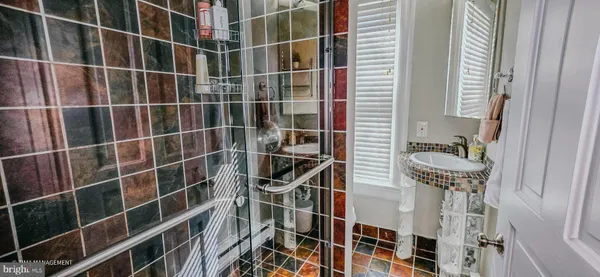 a bathroom with a window and a shower
