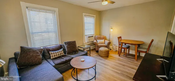 a living room with furniture and wooden floor