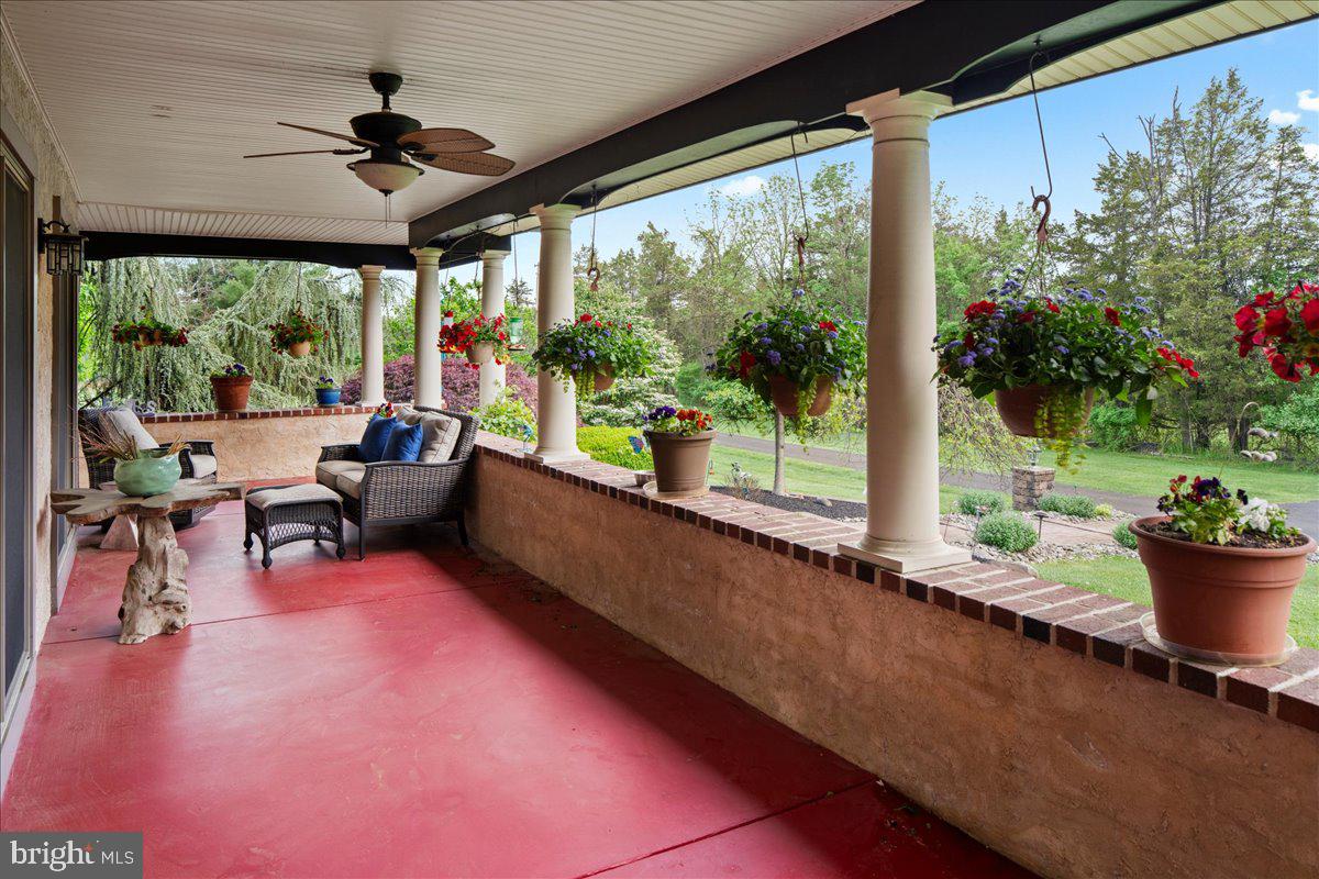 1121 Swamp Road Furlong, PA 18925 - Photo 9 of 50 Charming porch with vibrant blooms.