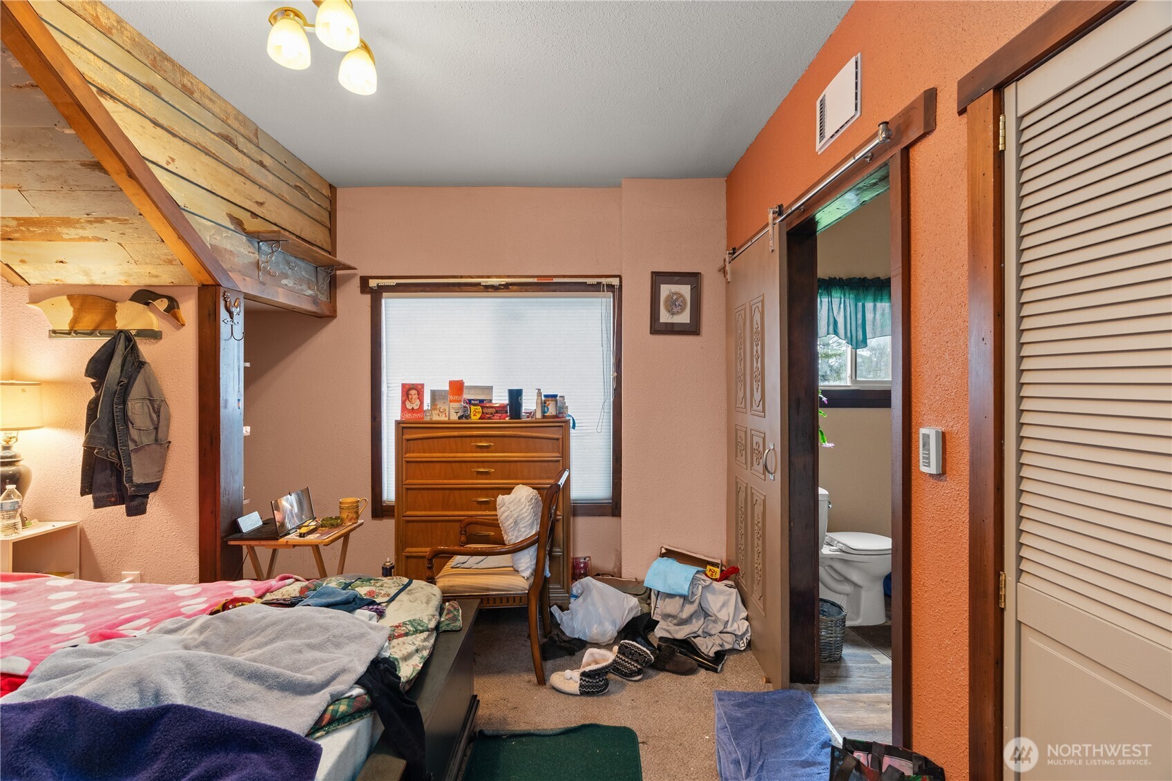 219 East Curtis Street Aberdeen, WA 98520 - Photo 5 of 29 a bedroom with a bed and wooden floor