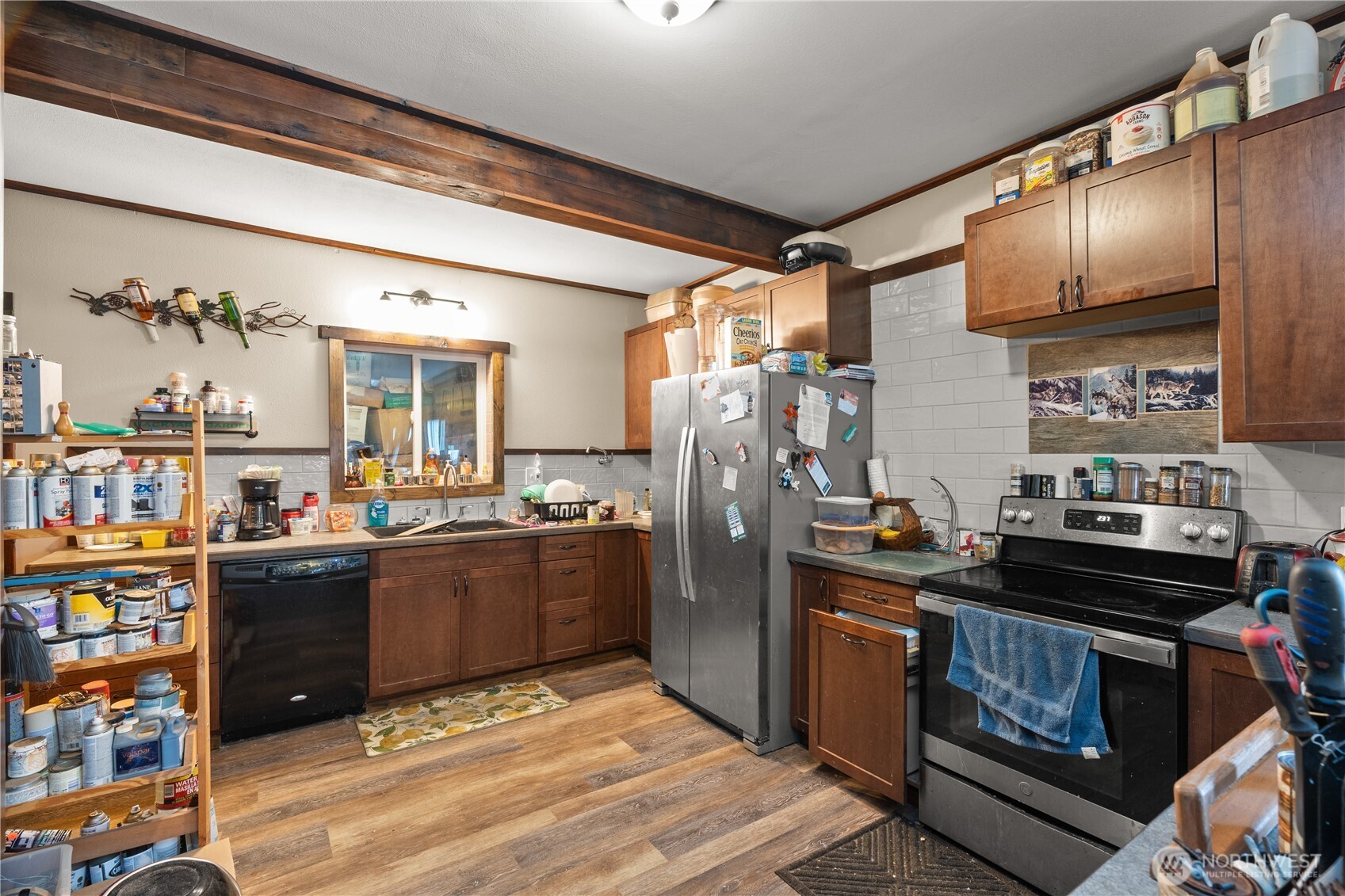 219 East Curtis Street Aberdeen, WA 98520 - Photo 10 of 29 a kitchen with stainless steel appliances kitchen island granite countertop a refrigerator stove and sink