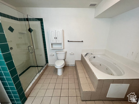 3013 North 100 West Provo, UT 84604 - Photo 17 of 18 Full bathroom featuring a shower stall, light tile patterned flooring, and a jetted tub