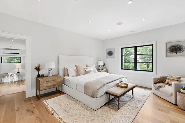 a bedroom with a bed and wooden floor
