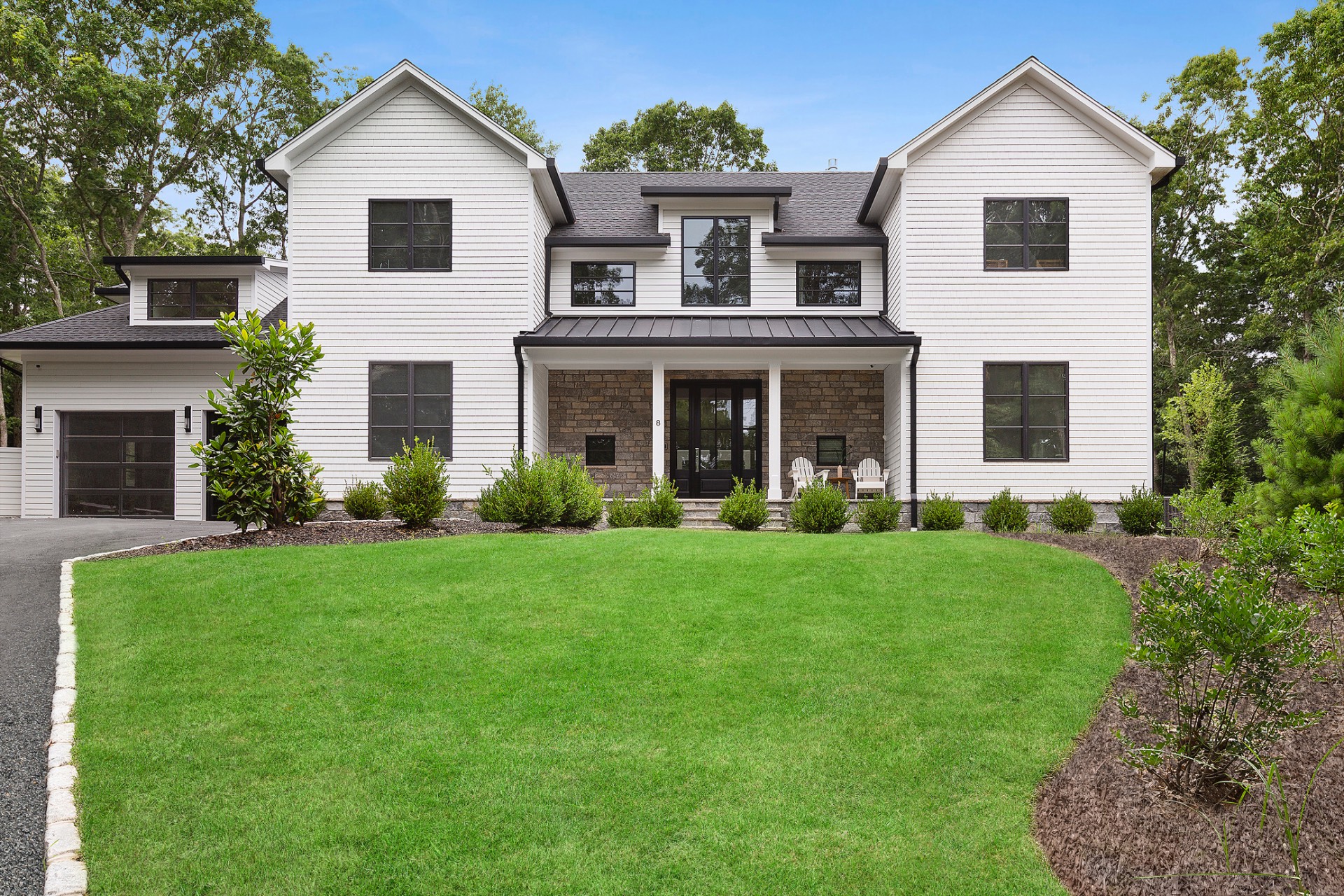 8 Crows Nest Lane East Hampton, NY 11937 - Photo 3 of 33 a view of a white house with a yard and plants