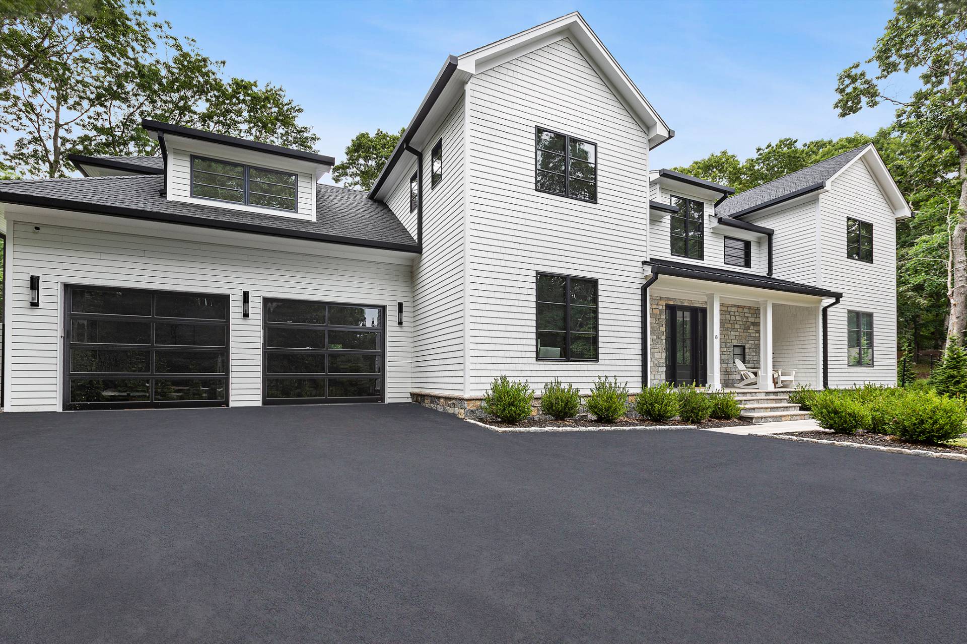 8 Crows Nest Lane East Hampton, NY 11937 - Photo 33 of 33 a front view of a house with a yard and garage