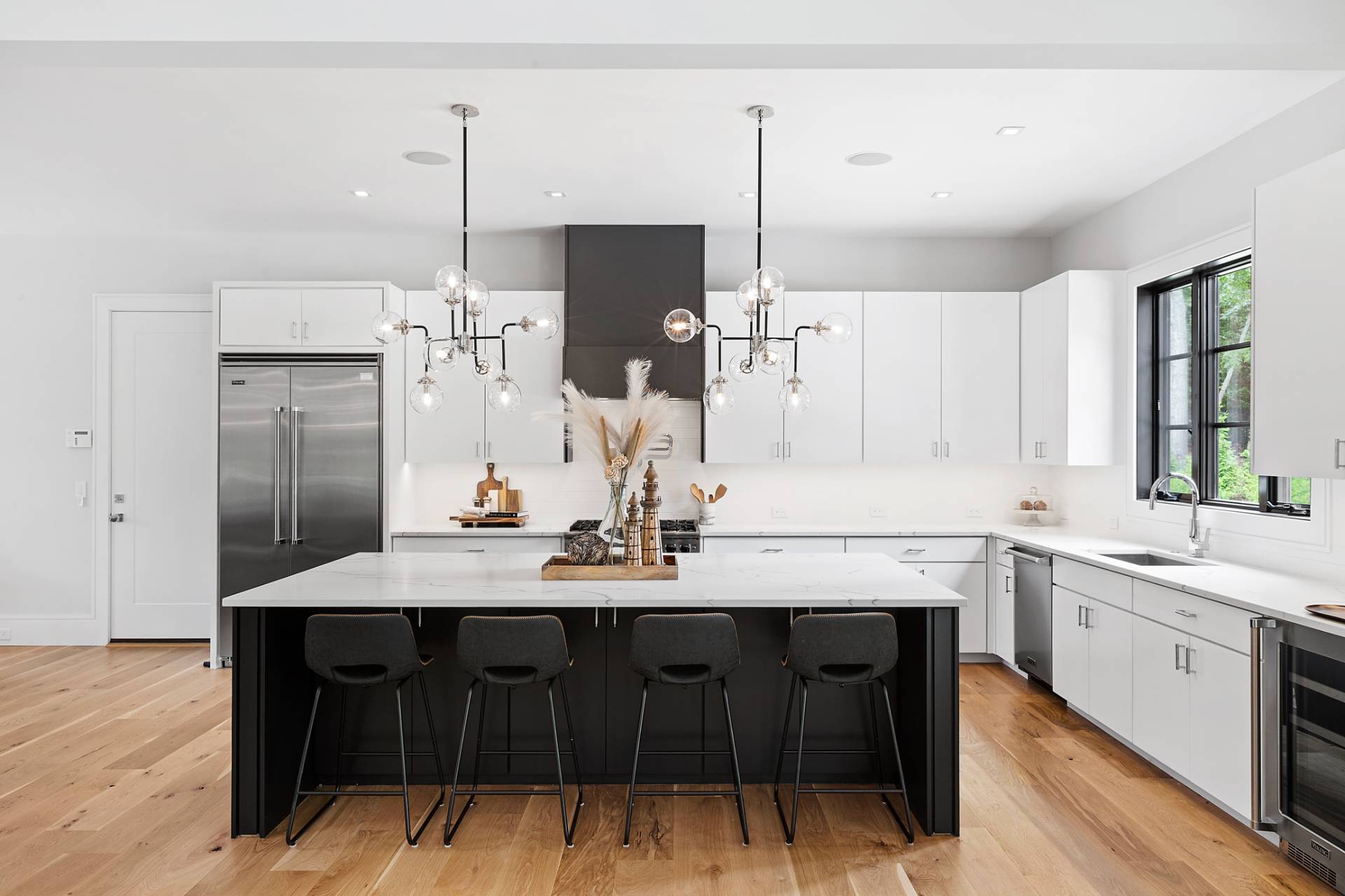 8 Crows Nest Lane East Hampton, NY 11937 - Photo 8 of 33 a kitchen with a sink a island a stove cabinets and stainless steel appliances