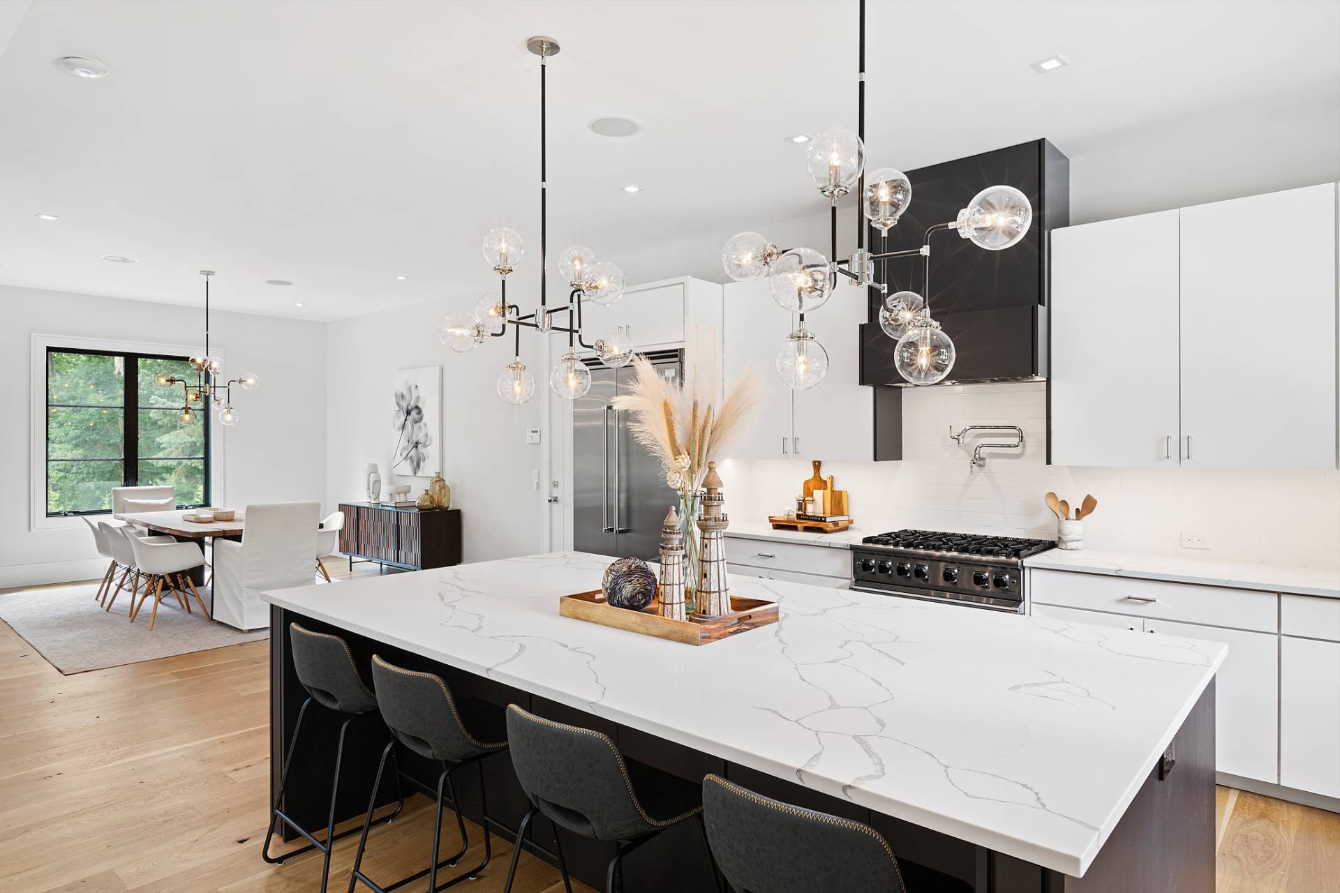 8 Crows Nest Lane East Hampton, NY 11937 - Photo 9 of 33 a kitchen with a table chairs and white cabinets