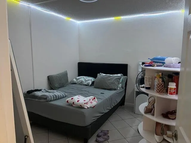 a bedroom with a bed and gym equipment