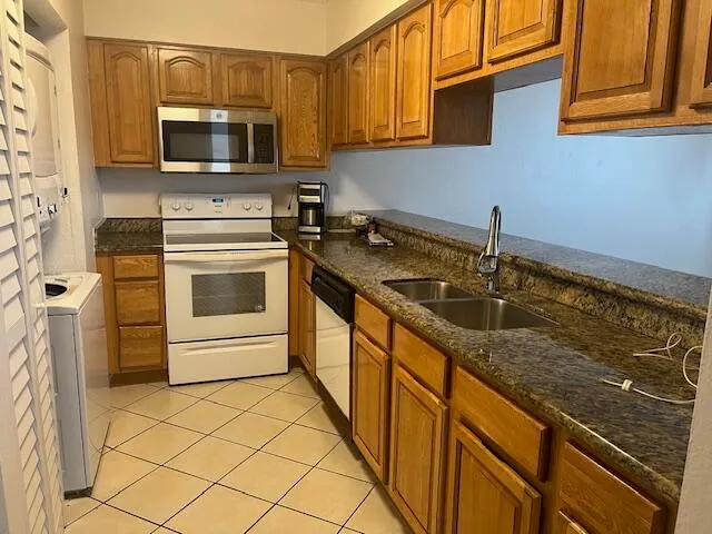 a kitchen with stainless steel appliances a stove sink and microwave