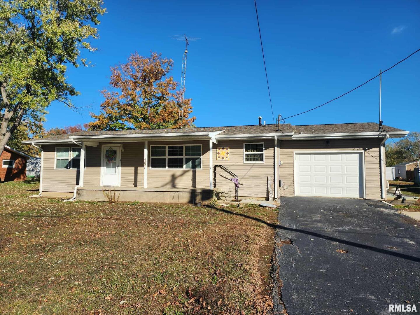 a house view with a sitting space and garden