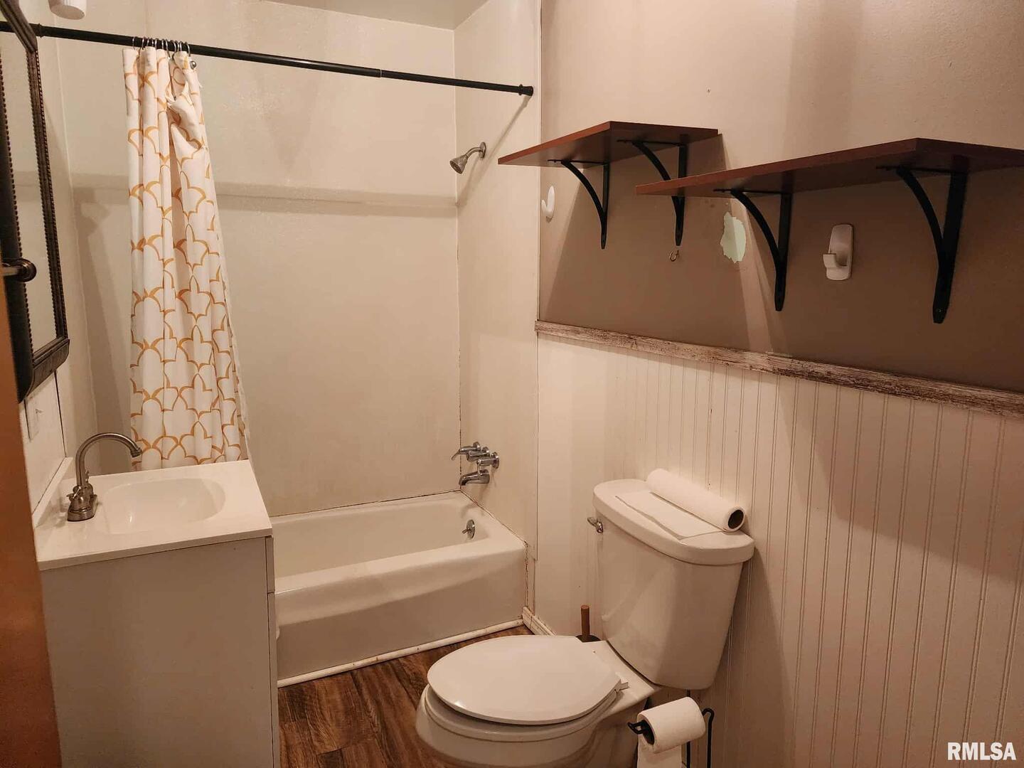 708 South Broadway Street Sesser, IL 62884 - Photo 8 of 15 a bathroom with a toilet and a shower curtain