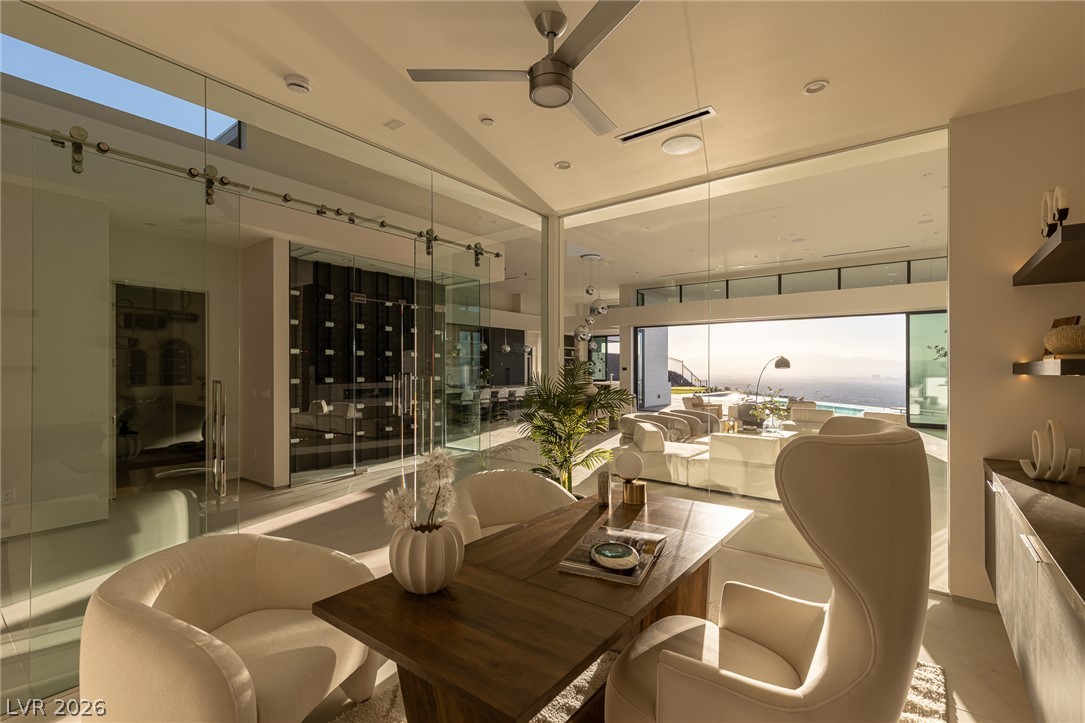 563 Grand Rim Drive Henderson, NV 89012 - Photo 18 of 70 A spacious home office seamlessly integrates with a living area, offering panoramic water views.