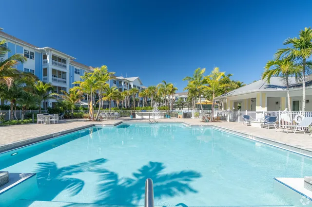 a view of swimming pool with outdoor seating and a garden