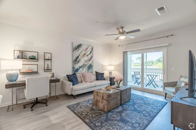 a living room with furniture and a large window