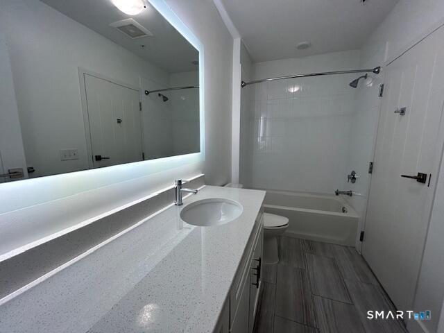 111 Morgan Street, Unit TH5 Stamford, CT 06905 - Photo 9 of 23 a bathroom with a granite countertop sink a toilet a bathtub and shower