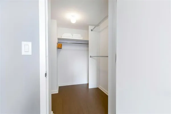 a view of walk in closet with empty racks