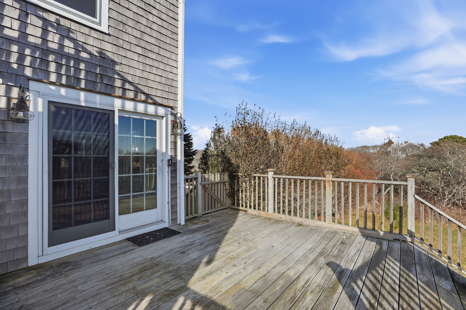 31 Flintlock Road Nantucket, MA 02554 - Photo 16 of 23 a view of a balcony with wooden floor and fence
